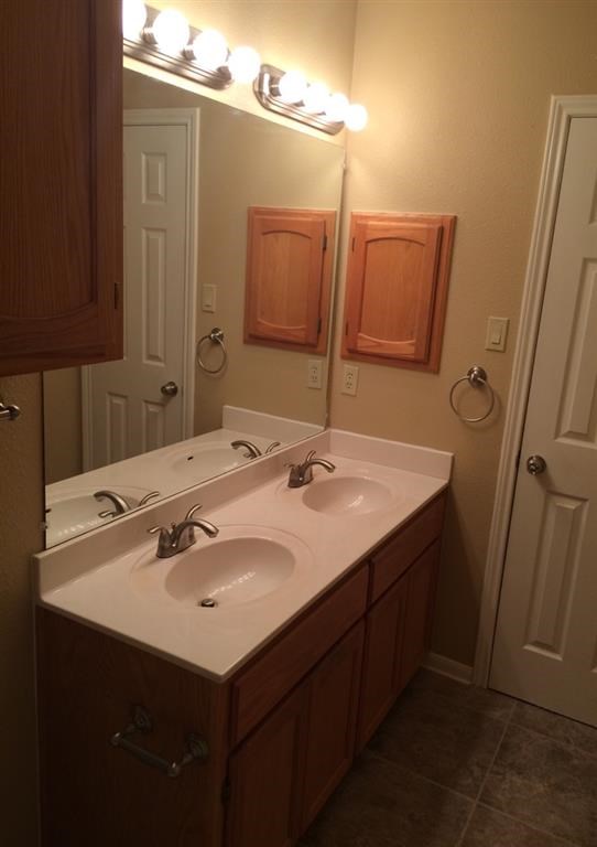 a bathroom with two sinks and a mirror