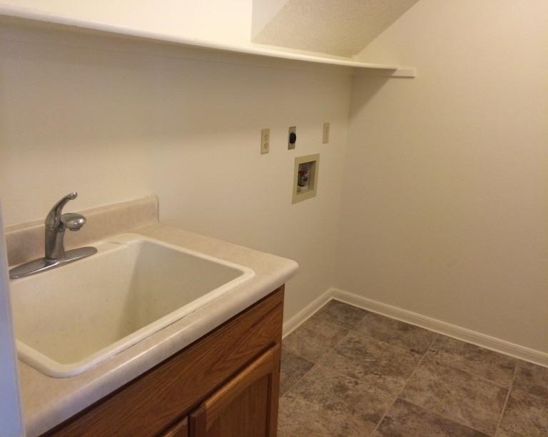 an empty bathroom with a sink in it