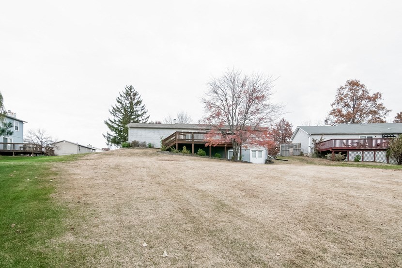 a house on a hill with a yard in front of it