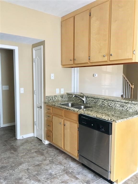 a kitchen with a sink and a dishwasher