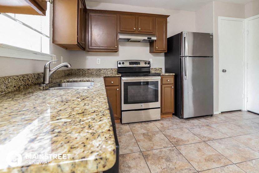 a kitchen with granite countertops and stainless steel appliances
