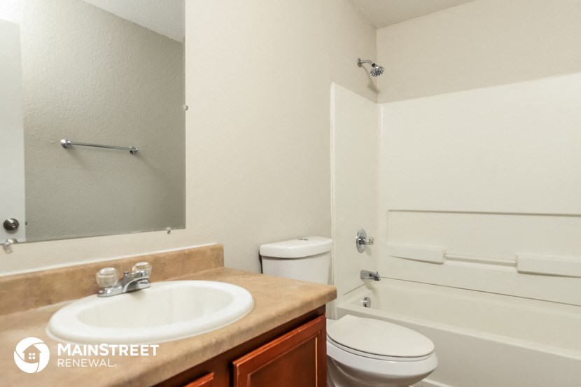 a bathroom with a sink and a toilet and a mirror