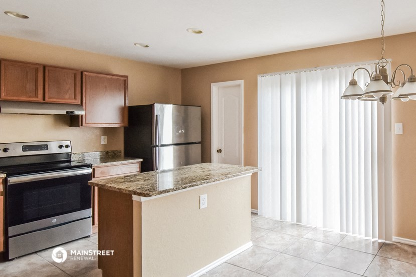 a kitchen with stainless steel appliances and a granite counter top