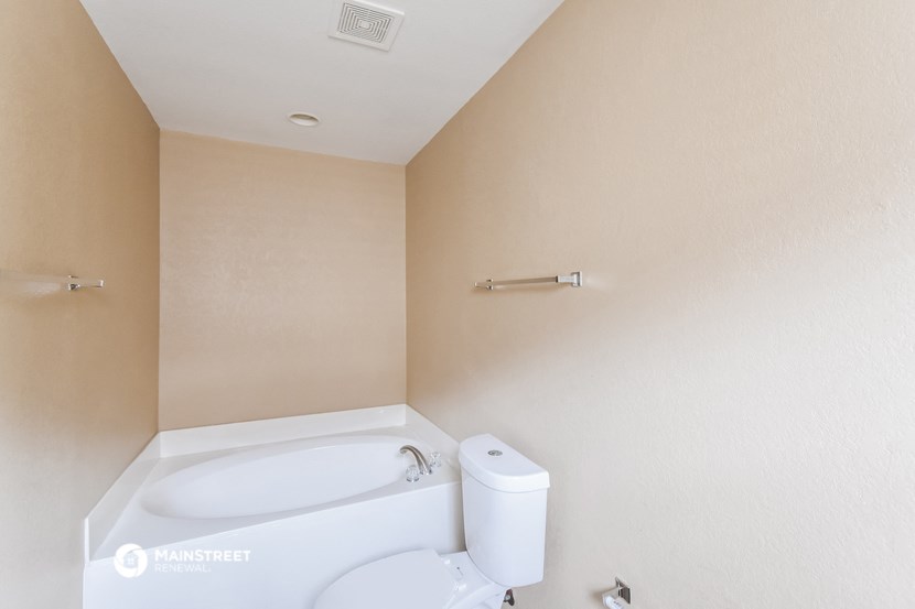 a bathroom with a toilet and a sink and a bath tub
