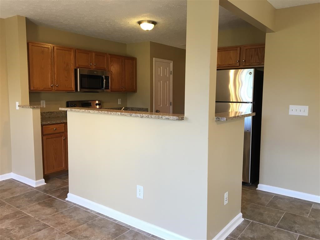 a kitchen with a counter and a refrigerator