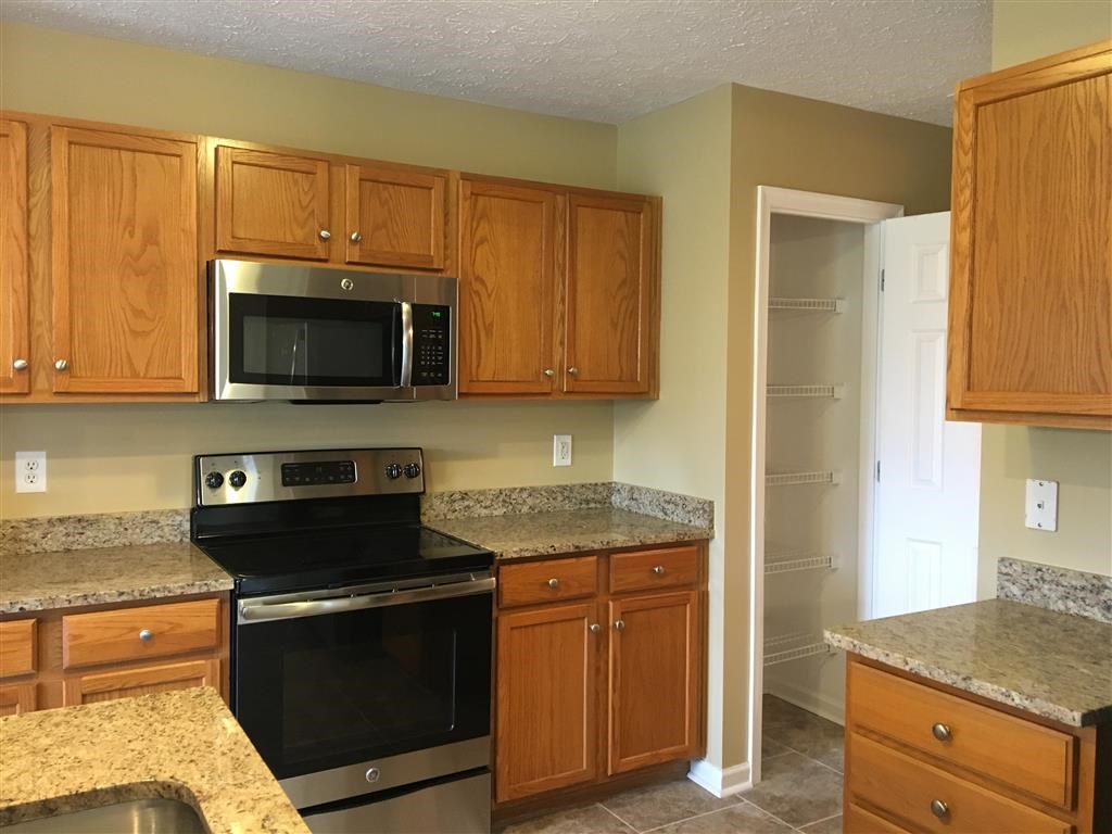 a kitchen with a stove and a microwave