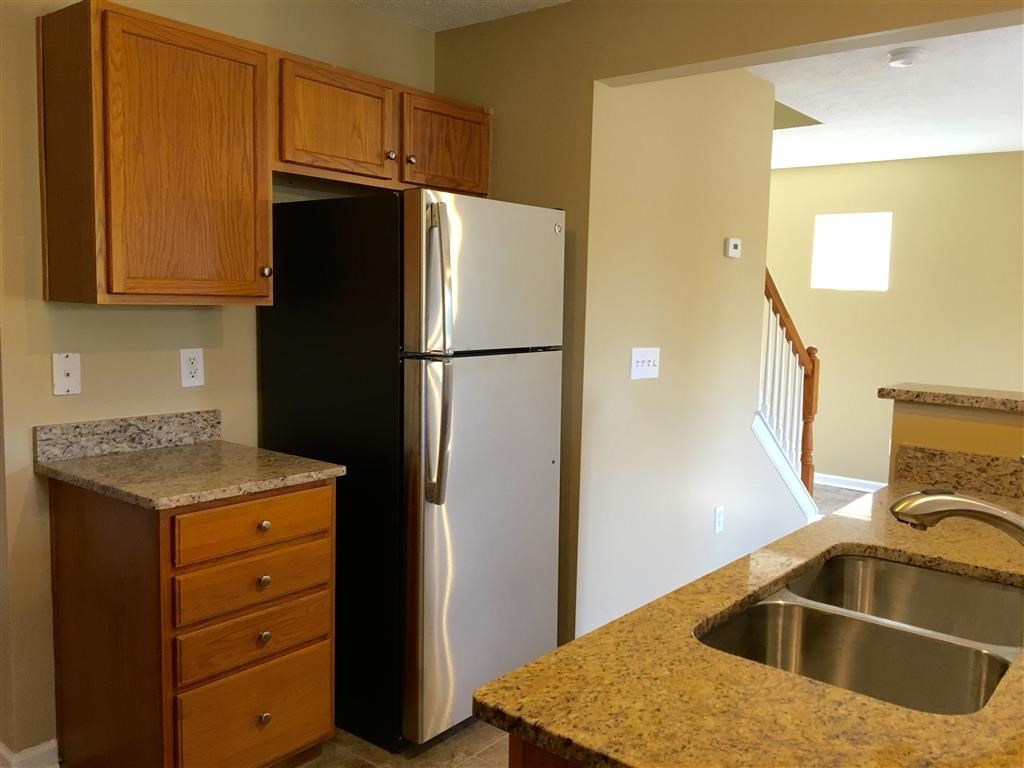 a kitchen with a sink and a refrigerator
