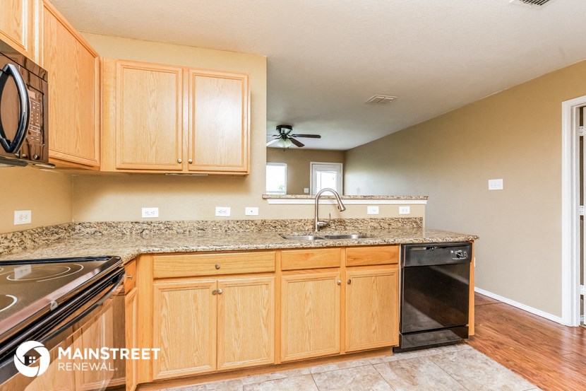 the kitchen is clean and ready to use with granite counter tops and stainless steel appliances