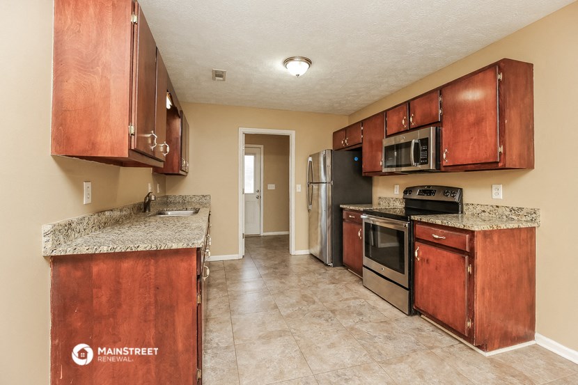 a kitchen with wooden cabinets and stainless steel appliances