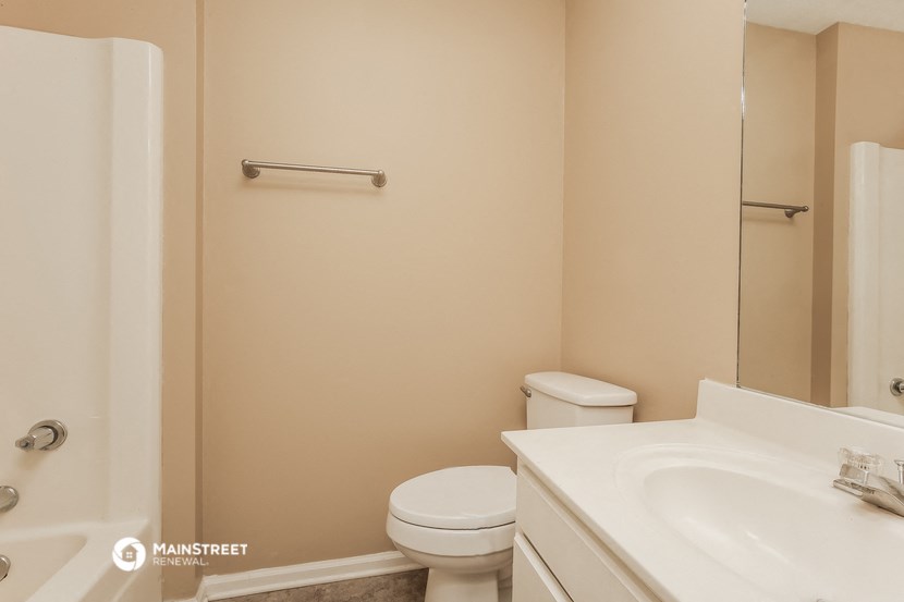 a bathroom with a sink toilet and a shower