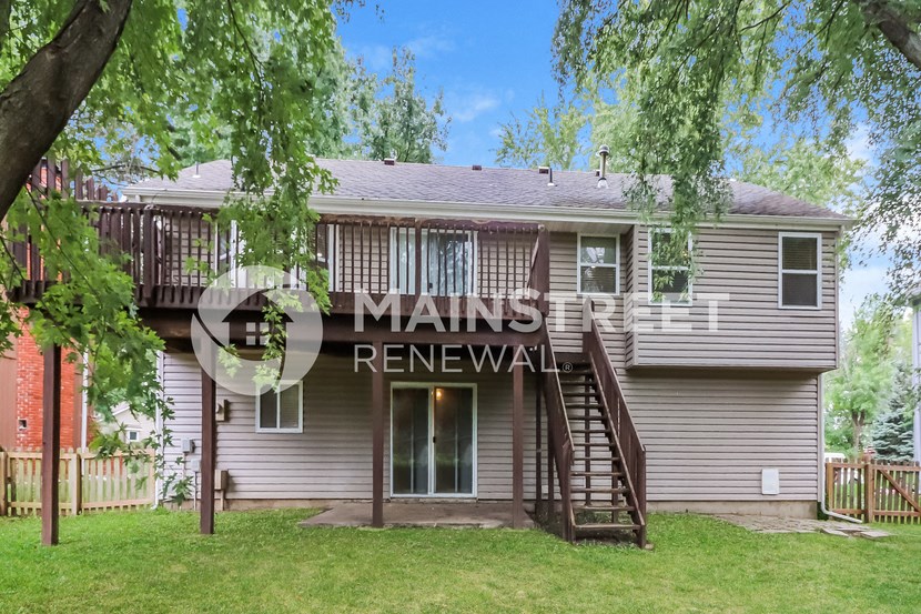 a house with a deck on the back of it