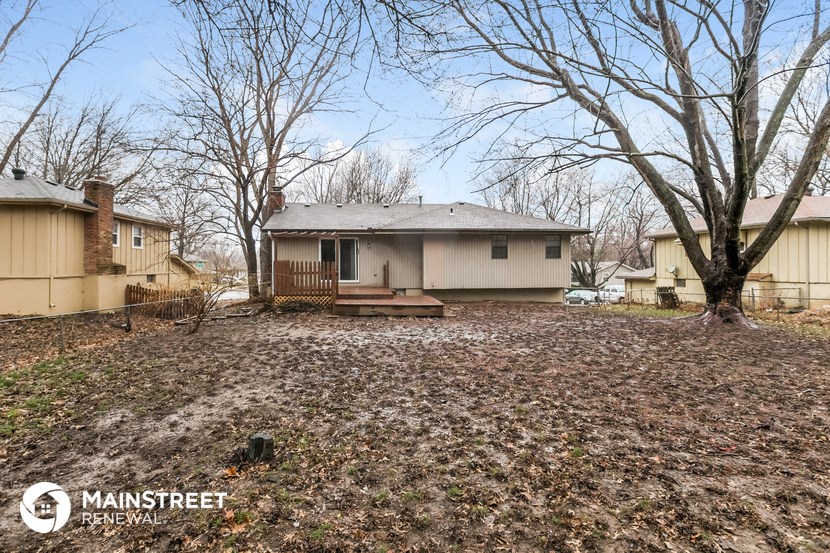 the front yard of a house with a yard and trees