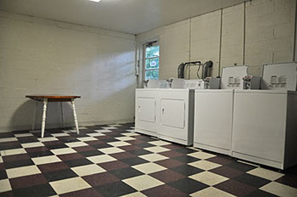 a kitchen with a checkered floor and white appliances