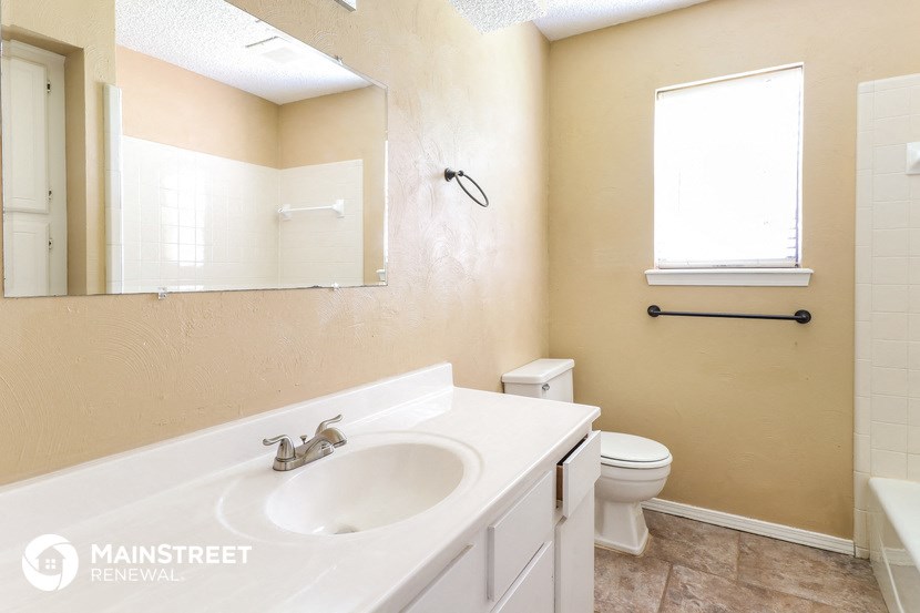 a bathroom with a sink and a toilet and a mirror