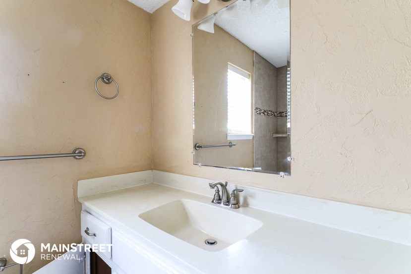 a small bathroom with a sink and a mirror