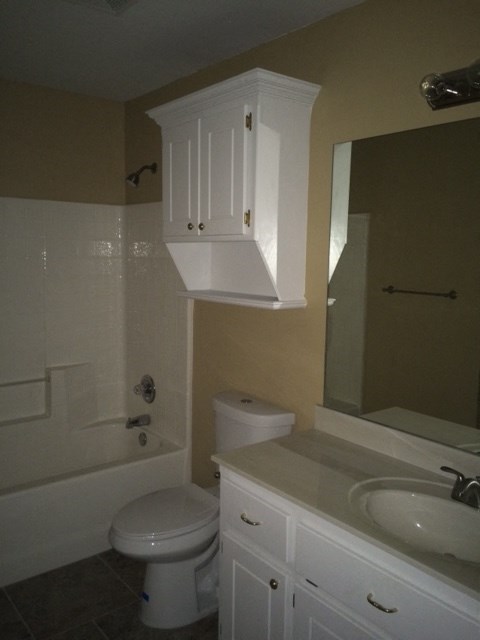 a bathroom with a toilet and a sink and a bath tub