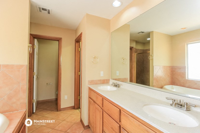 a bathroom with two sinks and a large mirror