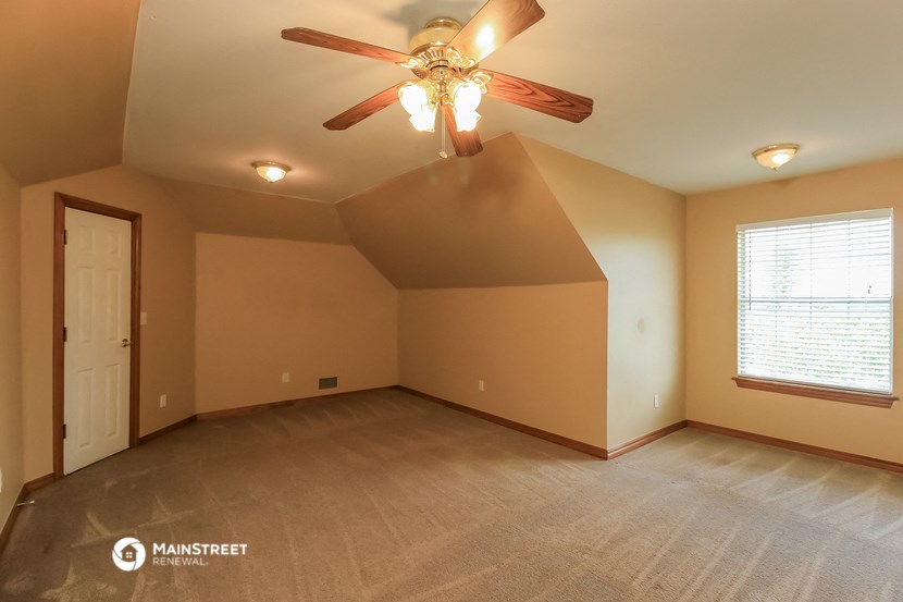 the master bedroom is spacious and has a ceiling fan
