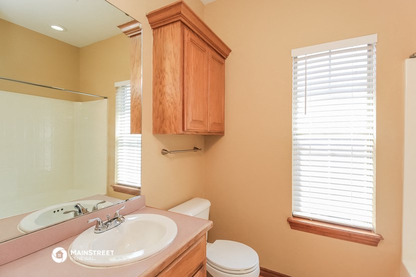 a bathroom with a sink and a toilet and a mirror