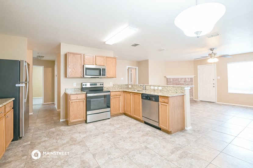 a kitchen with wooden cabinets and stainless steel appliances