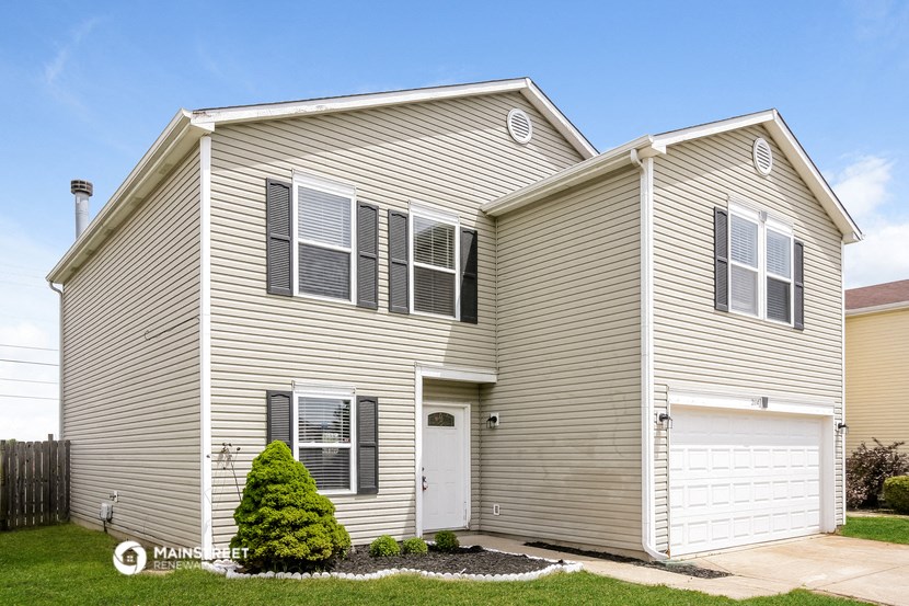 a white house with a white garage and a green yard