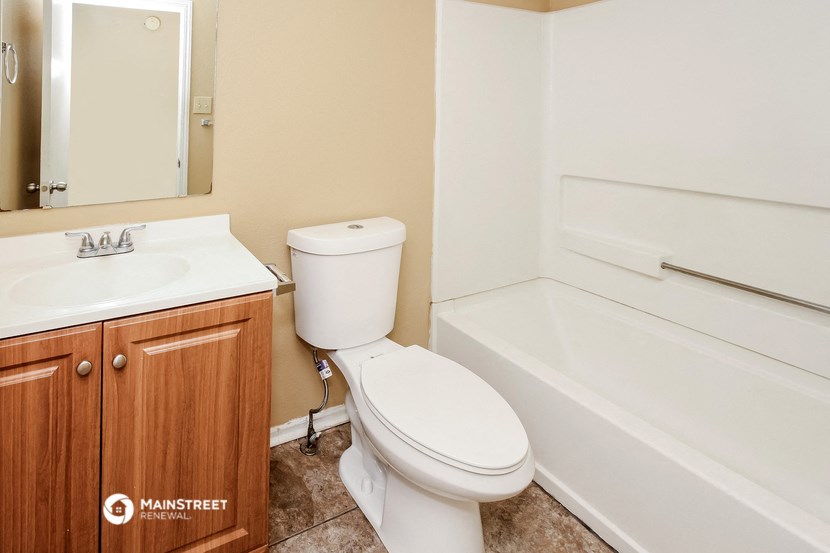 a bathroom with a toilet and a sink and a bath tub