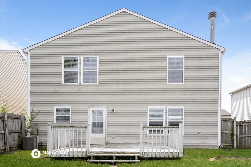 side view of a house with a porch and a deck