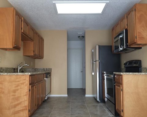 a kitchen with stainless steel appliances and wooden cabinets