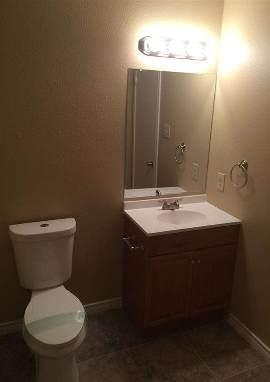 a bathroom with a toilet and a sink and a mirror