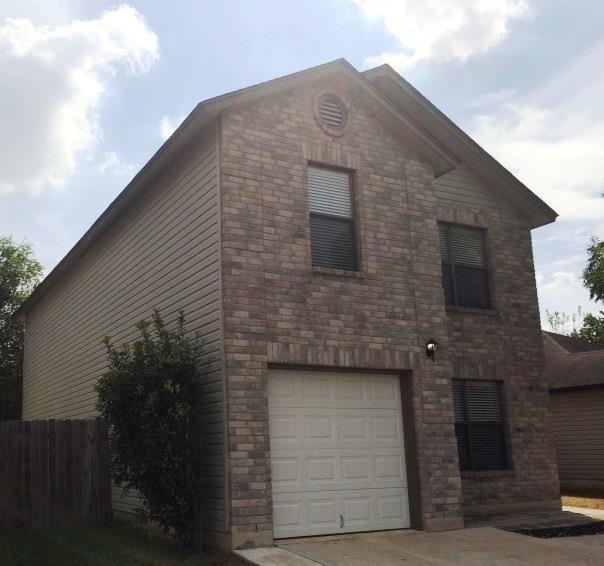 a brick house with a white garage door