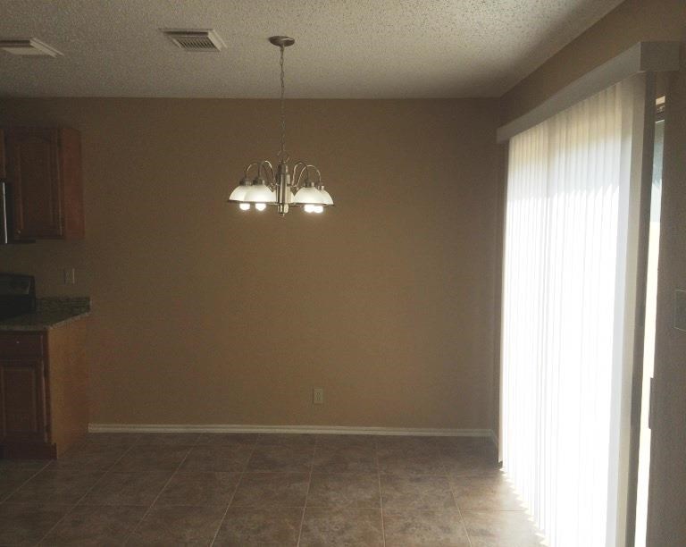 a dining room with a chandelier and a window