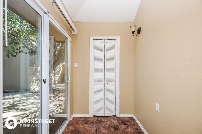 the entryway to the home has a door to the patio