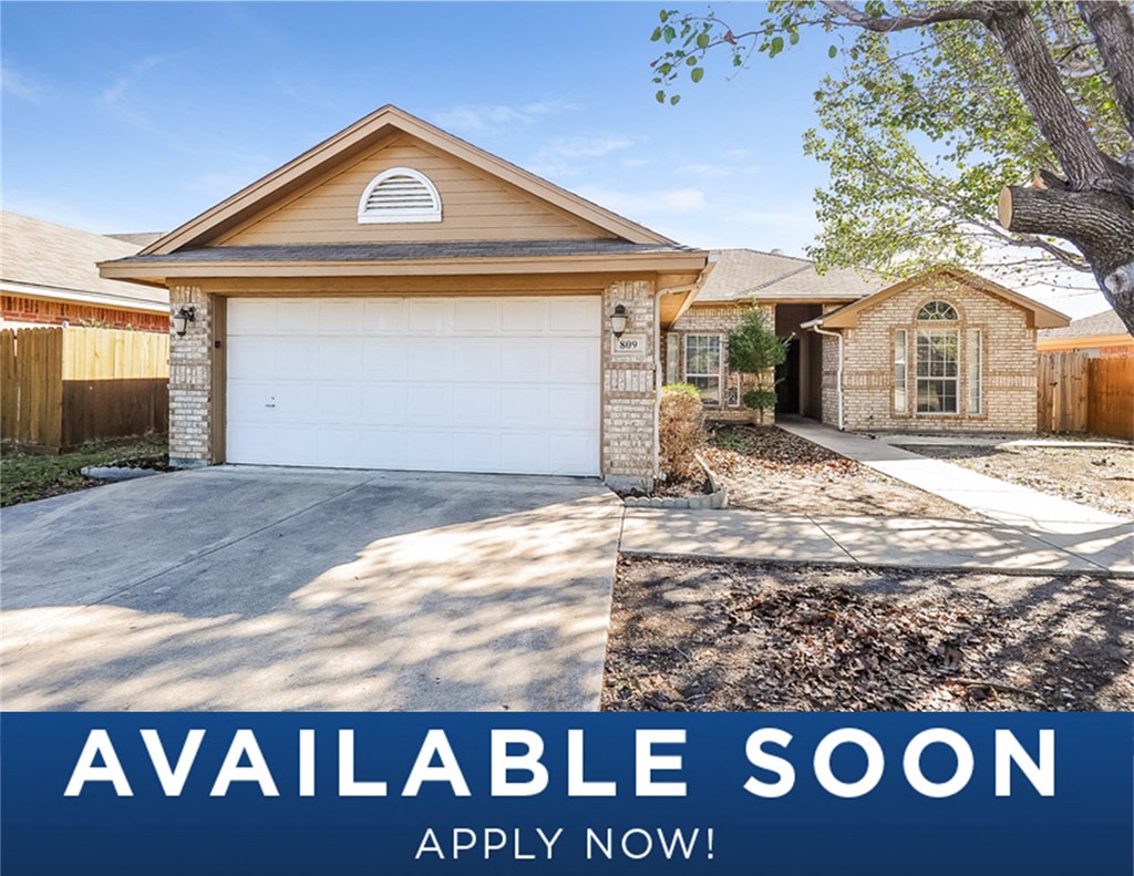 a home with a garage and a white door