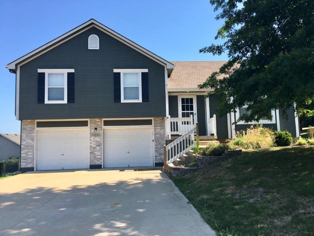 a house with a driveway and a garage door