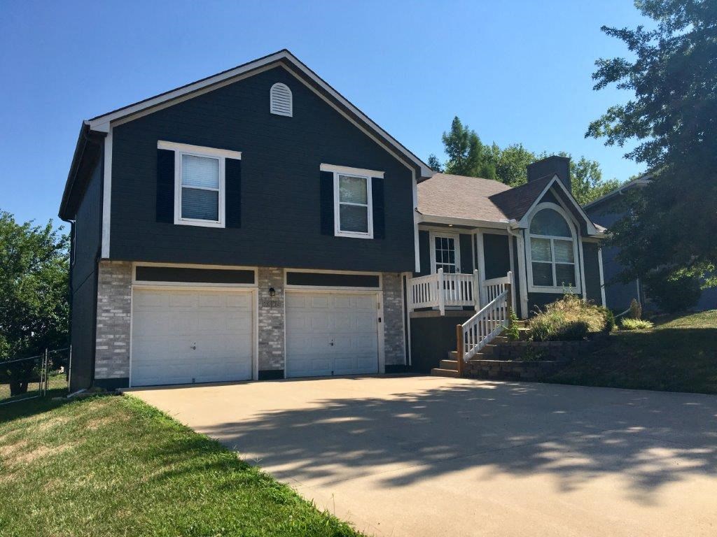 a house with a driveway and two garage doors