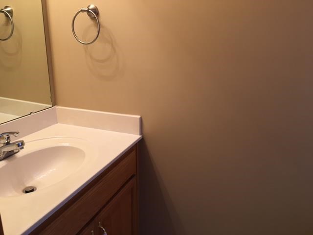 a bathroom with a white sink and a mirror