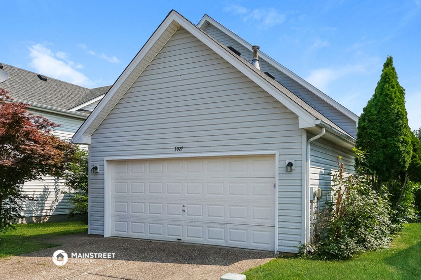 a white garage door on the side of a house