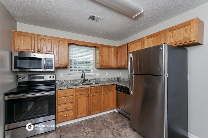 a kitchen with stainless steel appliances and wooden cabinets