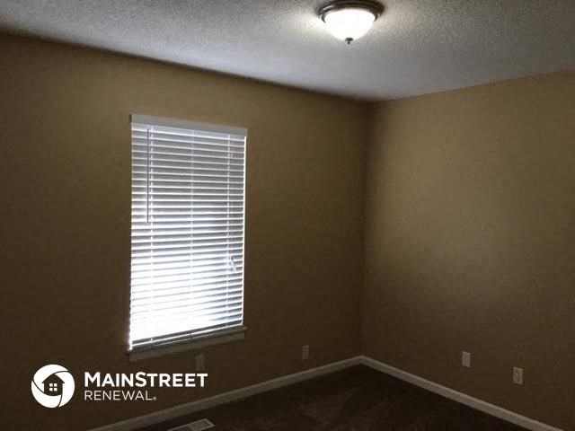 a living room with a window and a light