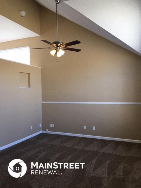 an empty room with a ceiling fan