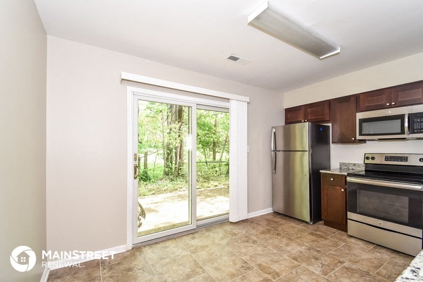 a kitchen with stainless steel appliances and a sliding glass door