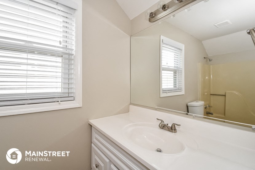a bathroom with a sink and a mirror and a shower