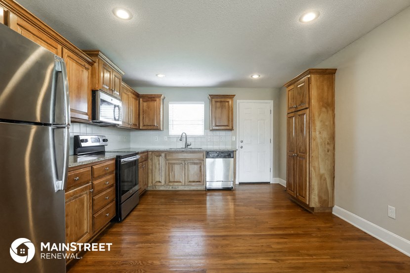 a kitchen with wooden cabinets and stainless steel appliances