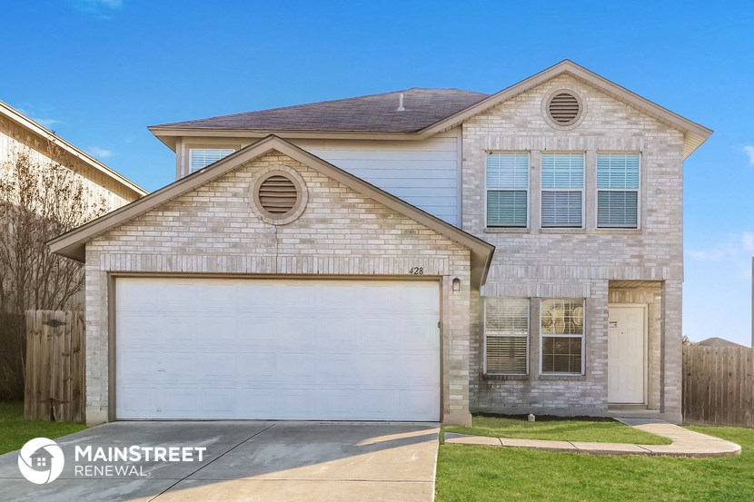 a white brick home with a white garage door