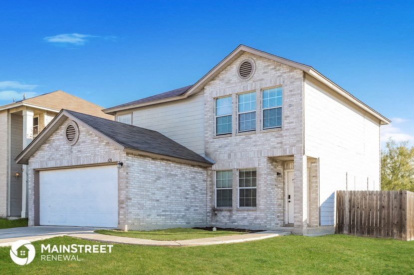 a white brick house with a white garage door