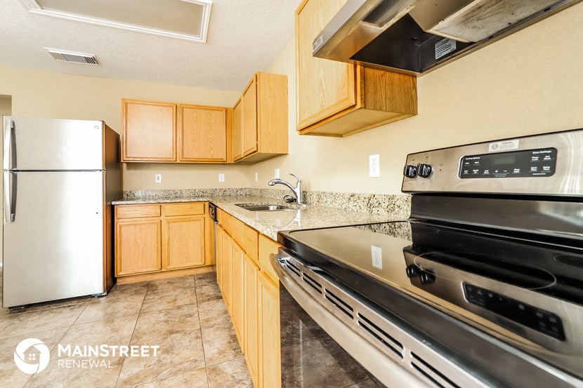a kitchen with stainless steel appliances and wooden cabinets