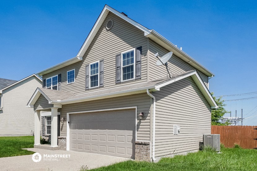 a house with a garage door and a satellite dish on it