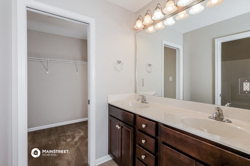 a bathroom with a sink and a mirror and a shower