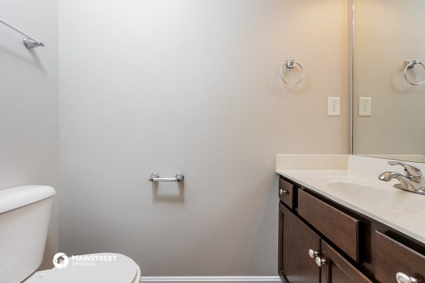 a bathroom with a sink and a toilet and a shower