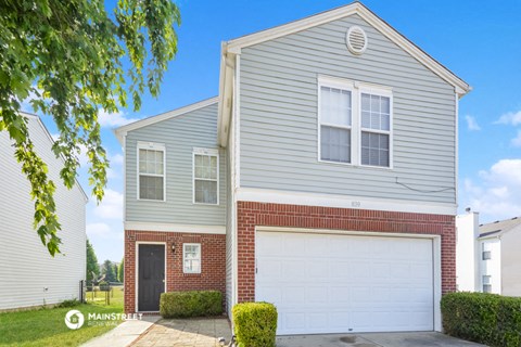 a house with a white garage door in front of it